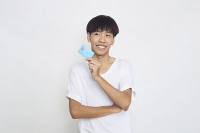 Portrait of smiling man standing against white background