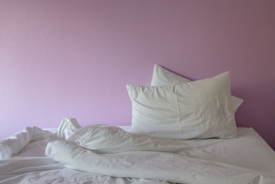 White blanket on bed against wall at home