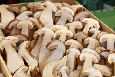 Close-up of halved porcini mushrooms in wooden box