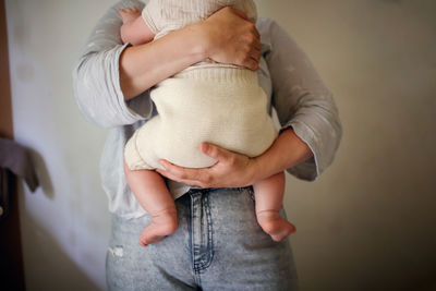 Mother holds her baby in eco-friendly diaper, conscious 