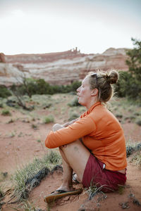 Profile portrait of a female desert hiker making a fish face