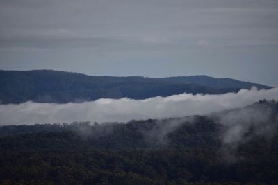 Scenic view of mountains against cloudy sky