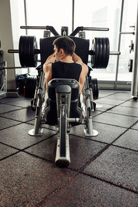 Side view of man exercising in gym