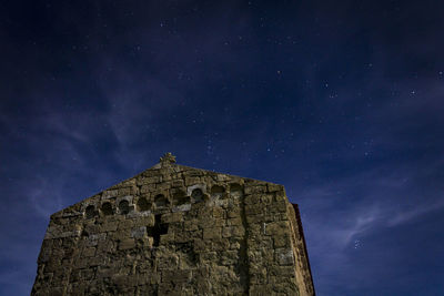 Low angle view of old building against sky at night