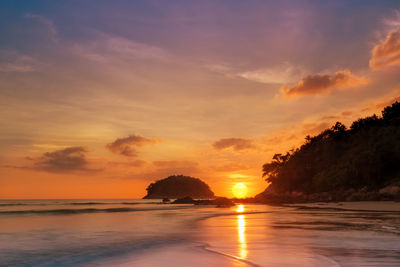 Scenic view of sunset at beach against sky