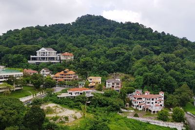 High angle view of trees and buildings against sky