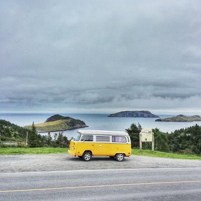 transportation, mode of transport, land vehicle, car, sky, road, cloud - sky, on the move, yellow, cloudy, street, travel, road marking, cloud, journey, the way forward, moving, tree, nature, outdoors