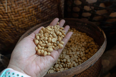 Cropped hand of woman holding wheat