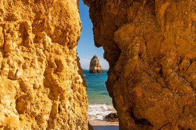 Rock formations in sea against sky