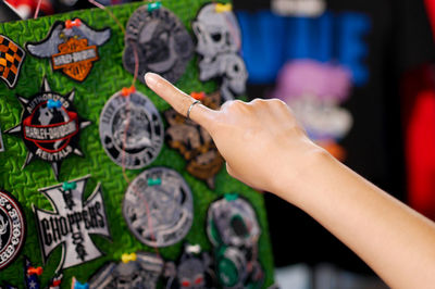 Cropped hand of woman pointing at patches