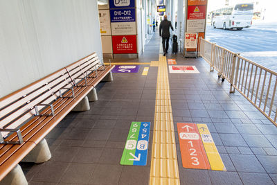 Rear view of people on tiled floor