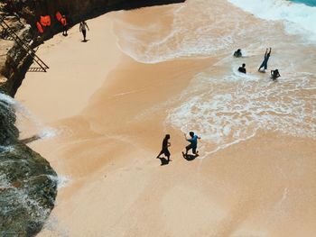 High angle view of people playing at beach