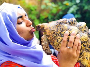 Close-up of woman holding tortoise