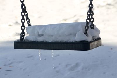 Close-up of snow covered swing
