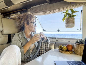 Young woman using mobile phone at home