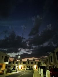 Street amidst buildings in city at night