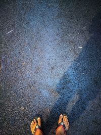 Low section of person standing on wet street