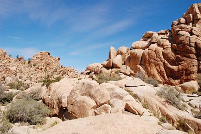 Low angle view of rock formations against blue sky