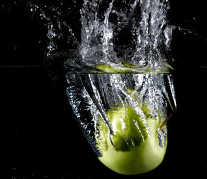 Close-up of water splashing against black background