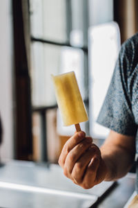 Hand holding popsicle, ice cream bar summertime