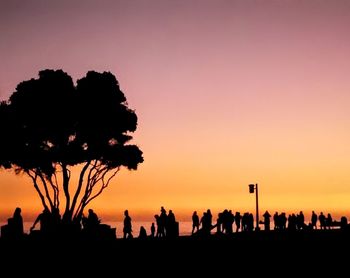 Silhouette people against sky during sunset