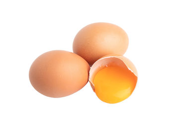 Close-up of eggs against white background