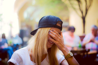 Close-up of woman covering face while laughing