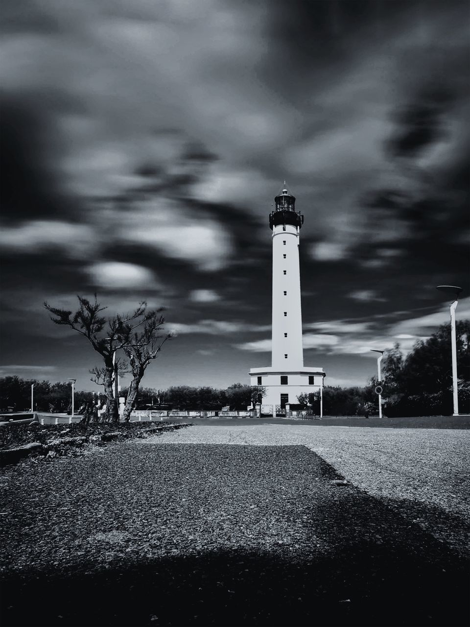 LIGHTHOUSE AND BUILDINGS AGAINST SKY