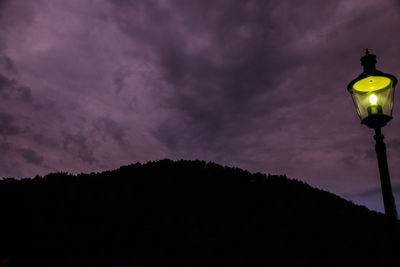 Low angle view of illuminated street light against sky at night