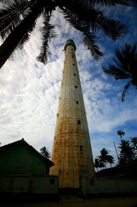 Low angle view of building against cloudy sky