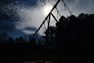 Low angle view of silhouette trees against sky at sunset