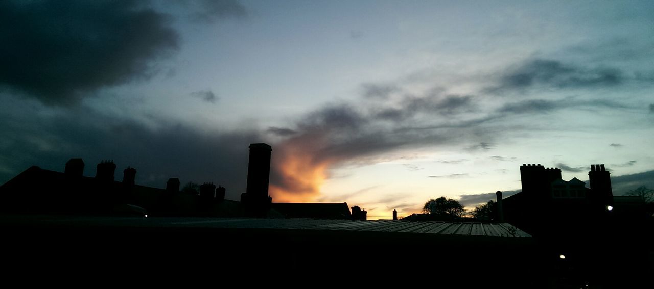 silhouette, building exterior, architecture, built structure, sky, cloud - sky, sunset, city, low angle view, building, cloudy, cloud, dusk, dark, residential building, residential structure, outline, dramatic sky, outdoors, weather