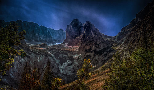 Scenic view of mountains against sky at night