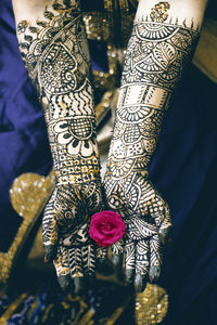 Low section of woman with tattoo on hand