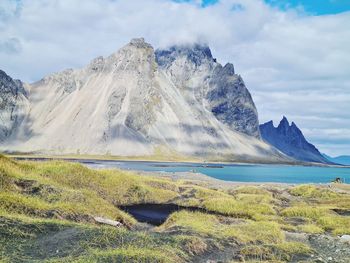 Scenic view of land and mountains against sky