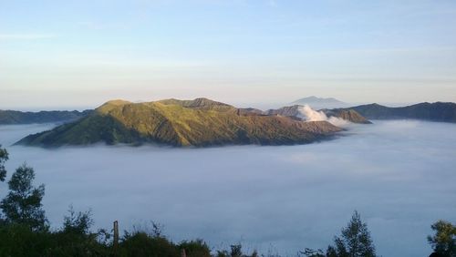 Scenic view of mountain against cloudy sky