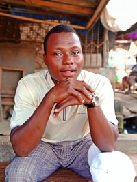 Portrait of young man sitting outdoors