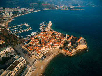 High angle view of sea and buildings in city