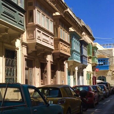 CARS PARKED ON STREET AGAINST BUILDINGS