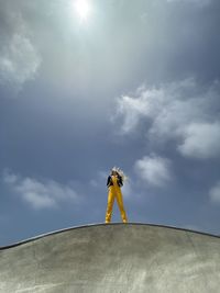 Low angle view of person standing against sky