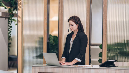 Receptionist and businessman at hotel front desk