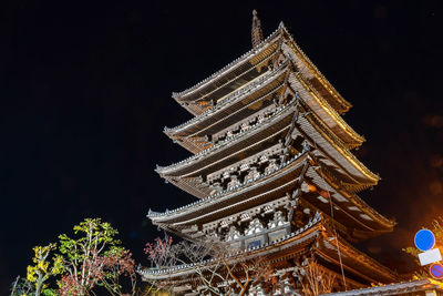 Low angle view of illuminated building against sky at night