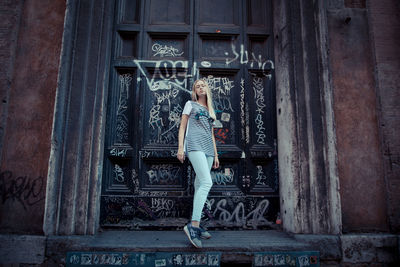 Woman standing against door