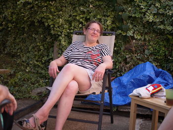 Portrait of smiling woman sitting on chair