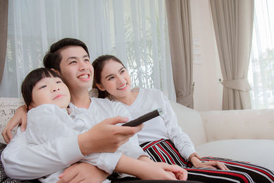Happy girl sitting on sofa