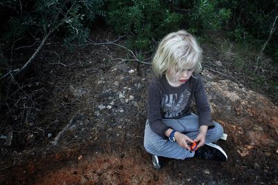 High angle view of boy playing with toy on field