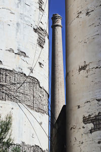 Low angle view of pipes by building