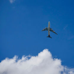 Low angle view of airplane flying in sky