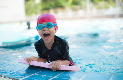 Portrait of girl screaming in swimming pool