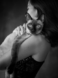 Portrait of woman holding kitten